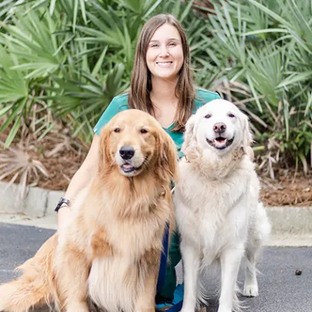 Dr. Beck with two golden retrievers 